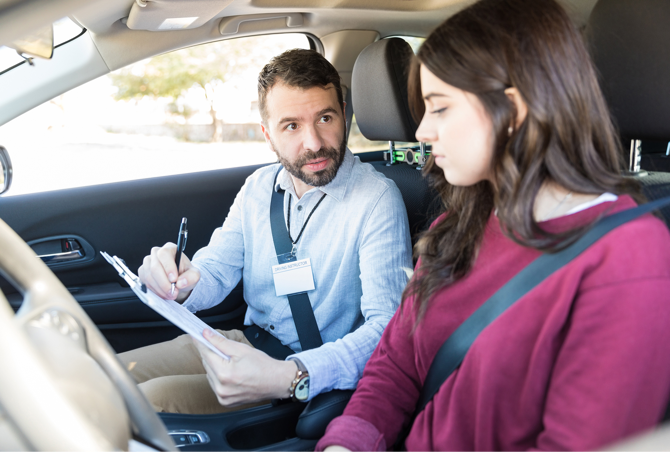 Driver Instructor showing Student Driver driving test